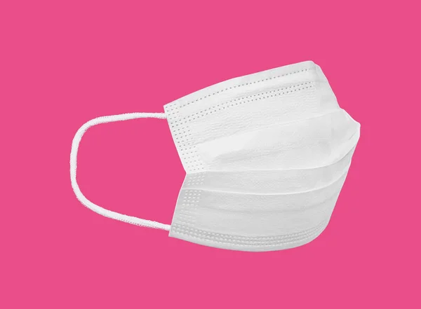 Healthcare and medicine concept. White medicine mask mockup profile view isolated on pink background with copy space