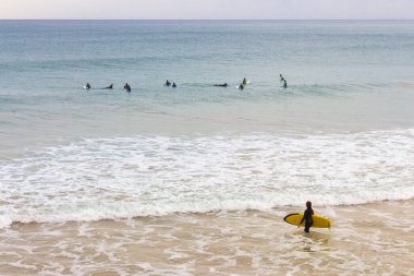 10 / 12 / 2019 - İspanya: Dalgalar halinde sörfçüler. Sörfçüler ve dalgalar sahile çarpıyor. Havadan deniz manzaralı suda yüzenler. Aktif yaşam tarzı. Olağanüstü bir spor. Sörf tahtalı sörfçülerin olduğu güzel bir deniz manzarası. Boş zaman aktivitesi.