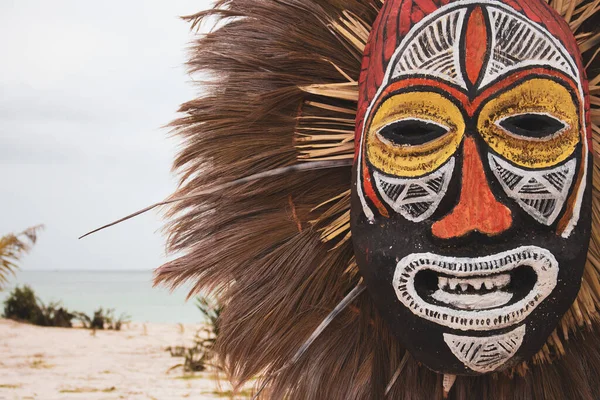 Africa - 01.30.2021: Carnival wooden mask. Tribal culture in Africa. Ancient african mask. Festival decoration. Funny face mask. African tradition. Craft masqaerade mask.