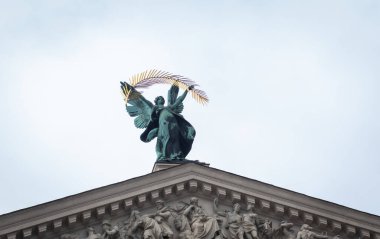 Lviv, Ukraine - 06/14/2021: Statue of Glory with wings on the roof of Opera House in Lviv. Facade of Theatre of Opera and Ballet, Ukraine. Classical architecture with monument. Lvov cityscape. Lviv sightseeing. 