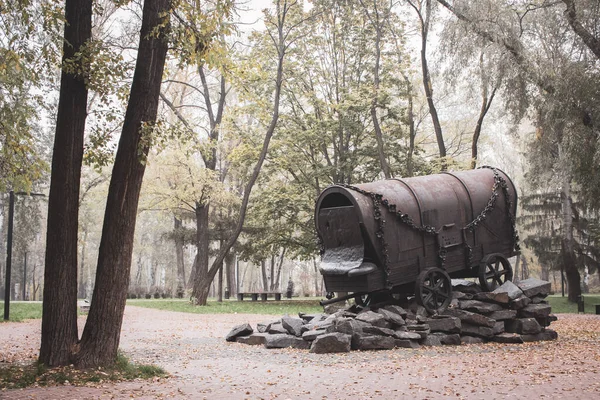 Kiev, Ukraine - 10/29/2020: Holocaust memorial in park called Babyi Yar in Kiev. Old wagon with bullet marks in the forest. Monument of jews victims in World War 2. Memory of destruction of people by fascism. Genocide history. 