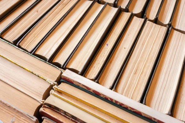 Stack of old books. Pile of vintage books. Literature and school concept. Library concept. Book shelf close up. Books background. Education concept. Knowledge and wisdom concept. Books top view.