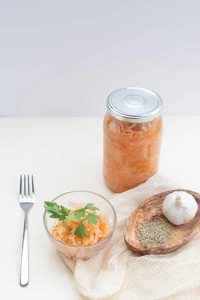 fermented food, sauerkraut or fermented cabbage with carrots on a light background