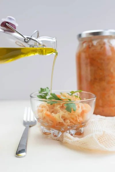 fermented food, sauerkraut or fermented cabbage in a glass jar on a light background