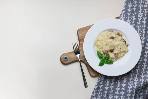 Tahta manzaralı fesleğenli bir tabakta gurme mantarlı risotto — Stok fotoğraf
