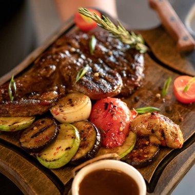 Kesme tahtasında ızgara et ve sebze. Yakın plan çekim. Yumuşak odak