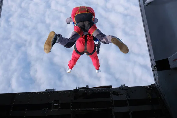 Skydiving. Tandem jump. Tandem is jumping out of a plane. The view from the plane.