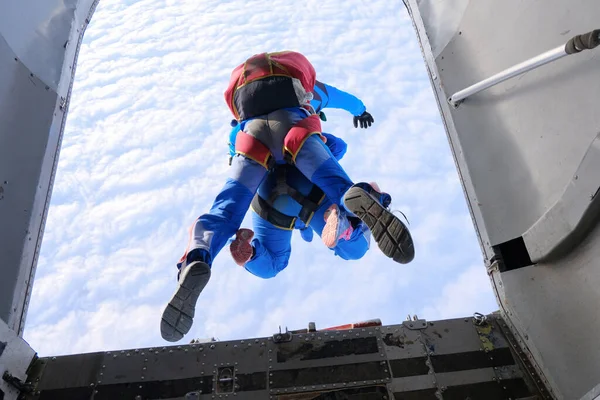 Skydiving. Tandem jump. Tandem is jumping out of a plane. The view from the plane.