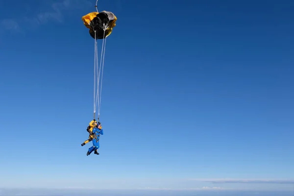 Skydiving. Tandem jump. The parachute deployment.