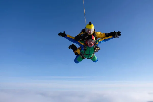 Skydiving. Tandem jump. Two guys are flying in the sky.