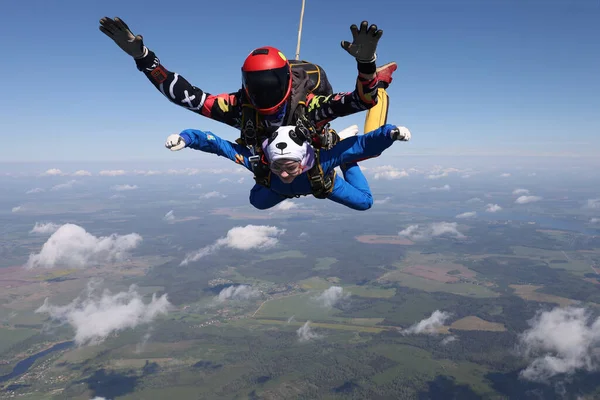 Skydiving. Tandem jump. A pretty girl and her instructor.