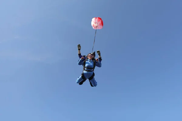 Skydiving. Tandem jump. A woman and her instructor.