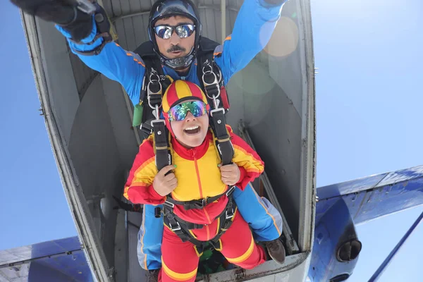Skydiving. Tandem jump. A spanish woman and her instructor.