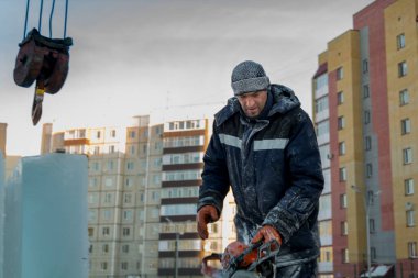 Kapüşonlu mavi ceketli bir işçinin portresi.