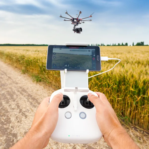 Obemannade copter. Man kontrollerar quadrocopter flyg. — Stockfoto