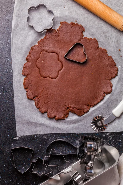 The process of baking chocolate cake base from shortcrust pastry.