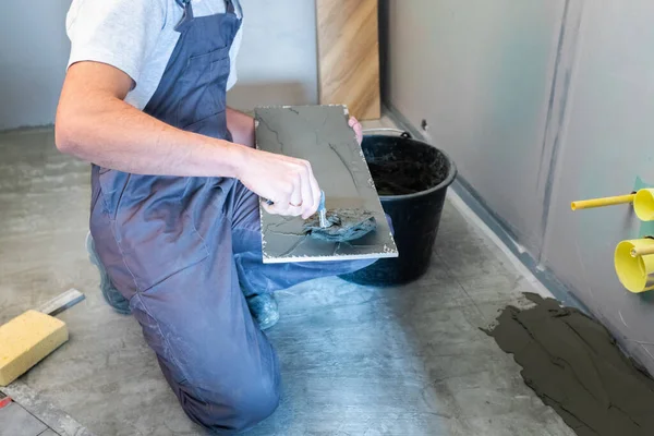 The process of laying ceramic floor tiles with a herringbone pattern. — Stock Photo, Image