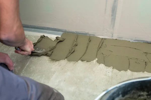 The process of laying ceramic floor tiles with a herringbone pattern. — Stock Photo, Image