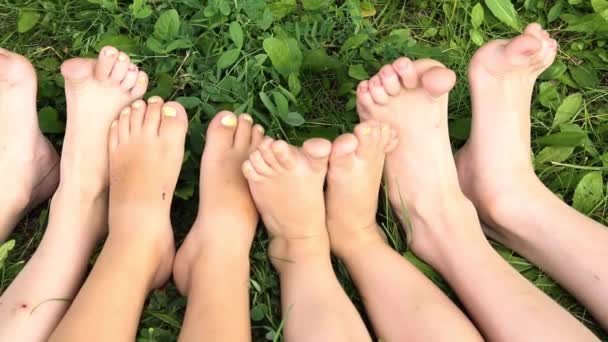 Niños Sentados Fila Con Los Pies Desnudos Hierba — Vídeo de stock