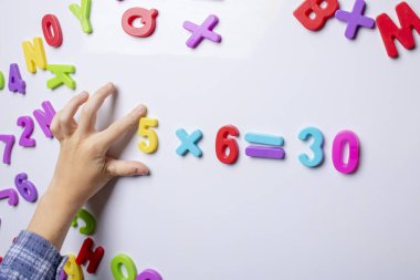 Little boy counting, hand holding numbers