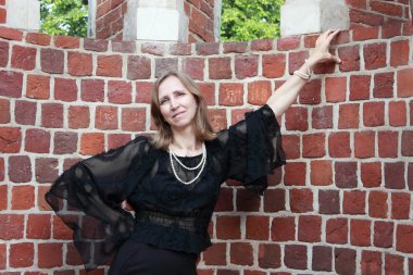 bir kadın tuğla duvara yakın durumda