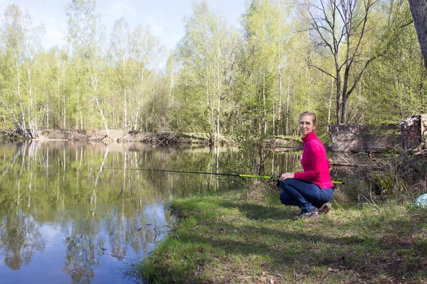 Woman fishing on daughter — Stock Photo, Image