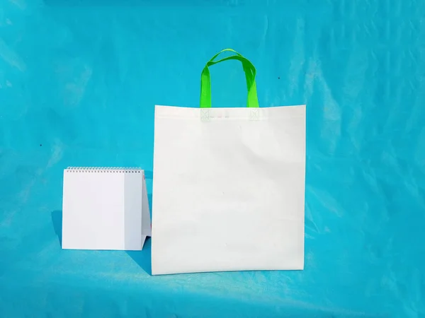 non woven fabric grocery bags on blue background. ECO Friendly Tote promotional products shopper bags