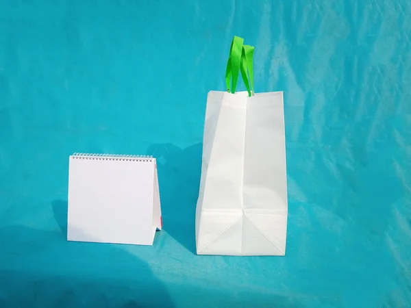 non woven fabric grocery bags on blue background. ECO Friendly Tote promotional products shopper bags