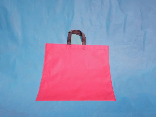 non woven fabric grocery bags on blue background. ECO Friendly Tote promotional products shopper bags