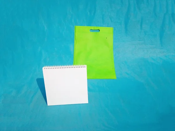 non woven fabric grocery bags on blue background. ECO Friendly Tote promotional products shopper bags