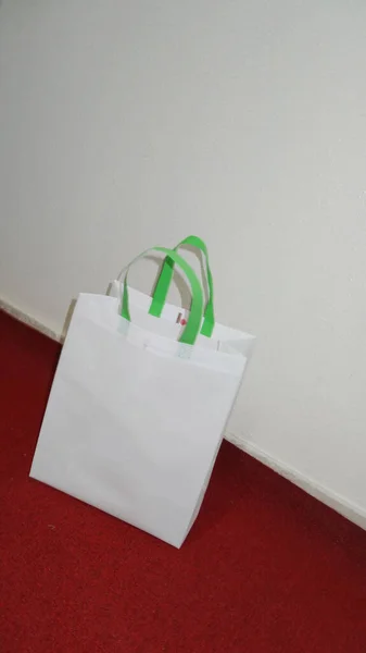 White Color Non Woven Bag with green handle loop. Mockup Bag with Copy Space for Text and Logo. Eco Friendly Concept