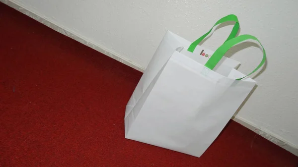 White Color Non Woven Bag with green handle loop. Mockup Bag with Copy Space for Text and Logo. Eco Friendly Concept