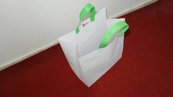 White Color Non Woven Bag with green handle loop. Mockup Bag with Copy Space for Text and Logo. Eco Friendly Concept