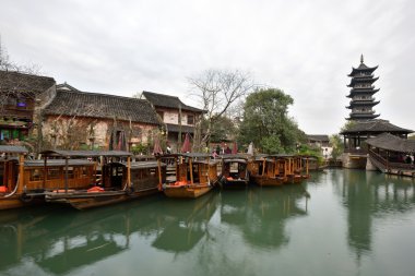 Traditional chinese boats in canal of Wuzhen clipart