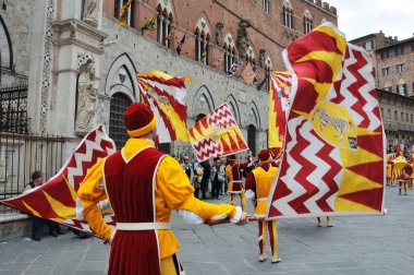 Siena, Italy - April 28: The contrada of Valdimontone (Valley of the Ram), parade through the streets of Siena in preparation for the Palio, April 28, 2013 in Siena, Italy clipart