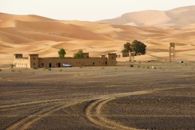 Traditional berber house in sand dunes