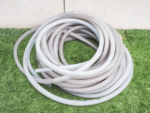 Rubber tube for watering plants in the garden — Stock Photo, Image