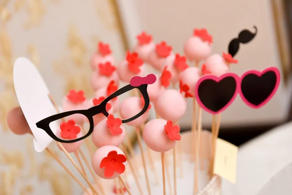 Pink lollipop with red flower and and fun eyeglasses — Stock Photo, Image