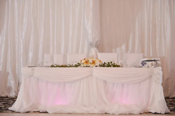 Table for groom, bride, godfather, godmother on a wedding day