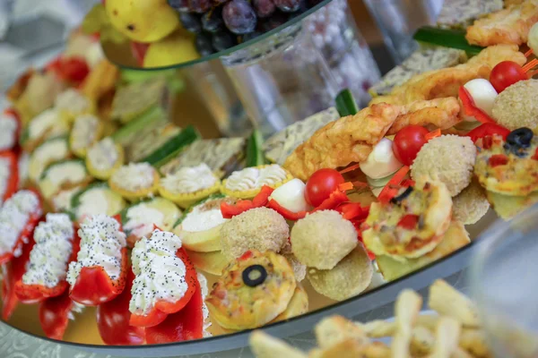 Cheese with vegetables and meat arrangement on a mirror for a wedding party — Stock Photo, Image