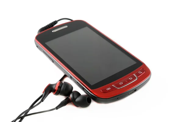 Red mobile phone with headsets — Stock Photo, Image