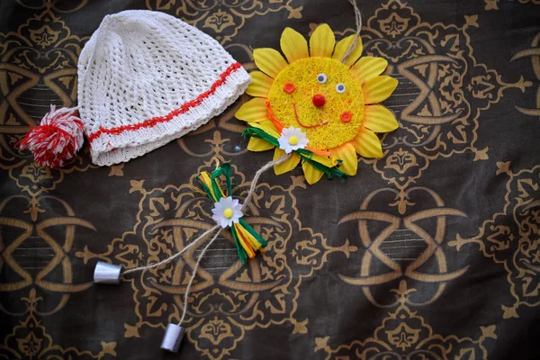 The cap white with red border children near a sunflower paper — Stock Photo, Image