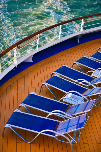 Blue sunbeds aligned on the deck — Stock Photo, Image