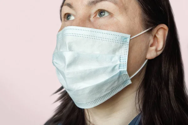 Portrait of an adult woman wearing a medical face mask protecting against respiratory diseases transmitted by airborne droplets such as coronavirus and flu