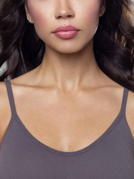 Cosmetics, makeup and trends. Bright lip gloss and lipstick on lips. Closeup of beautiful female mouth with natural lip makeup. Beautiful part of female face. Perfect clean skin in natural light