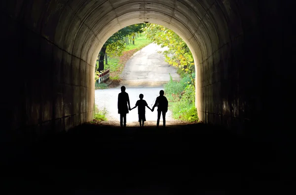 Family holding hands in the tunnel — Stock Photo, Image