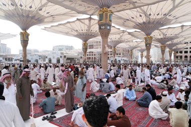 Muslims after Friday prayers  front of the Nabawi Mosque, Medina clipart