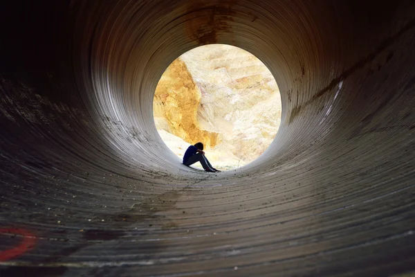 Joven deprimido sentado en el desagüe — Foto de Stock