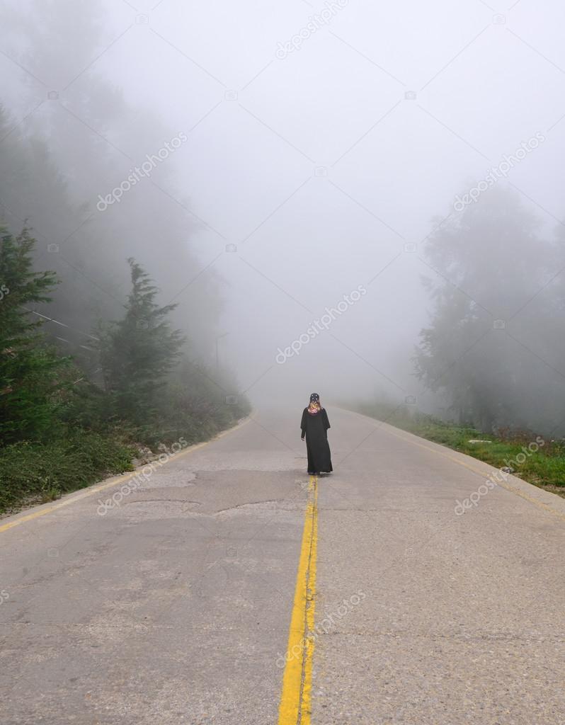 Silhouette of woman in misty fog