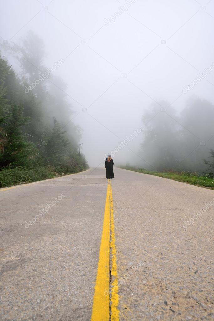 Silhouette of woman in misty fog